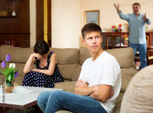 Spouses quarrelling while their son sitting