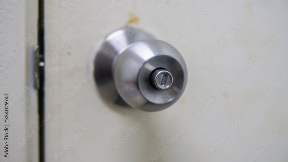 Close up view of metal brass door knob. A handle on a door that is turned to release the latch. Selective focus. Close up view of metal brass door knob. A handle on a door that is turned to release the latch. Selective focus.