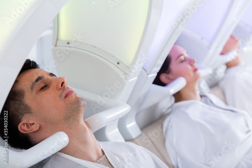 People relaxing in  massaging chairs for washing hair