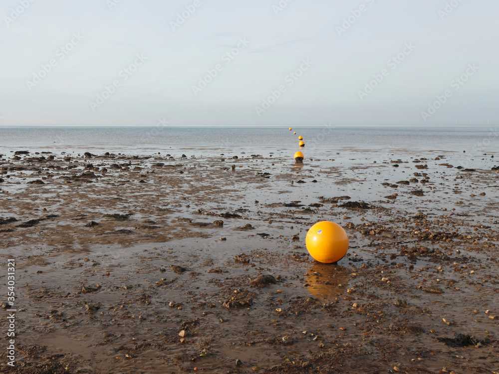 A line of buoys leading to sea in Whitstable, England