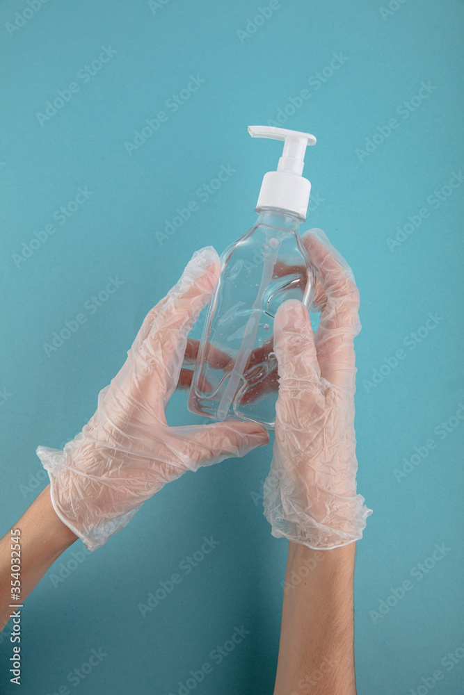 Fototapeta premium Hands in rubber gloves using wash hand sanitizer antiseptic gel pump dispenser for protection coronavirus, germ and bacteria, health care concept,