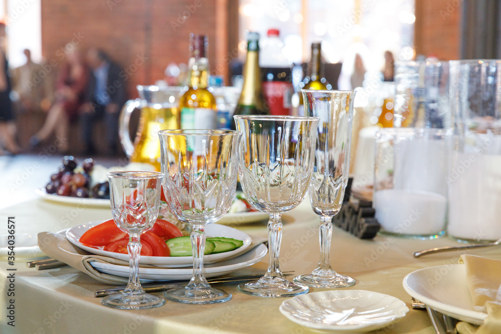 Fototapeta premium Table setting, glasses on table in restaurant 