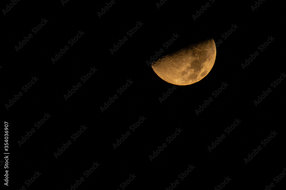 Big half moon showing details of moon's surface with black background Big half moon showing details of moon's surface with black background