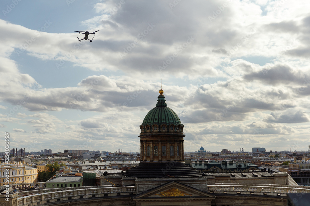 Drone with digital camera hovering over city