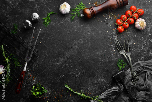 Black stone cooking background. Top view. Free copy space.