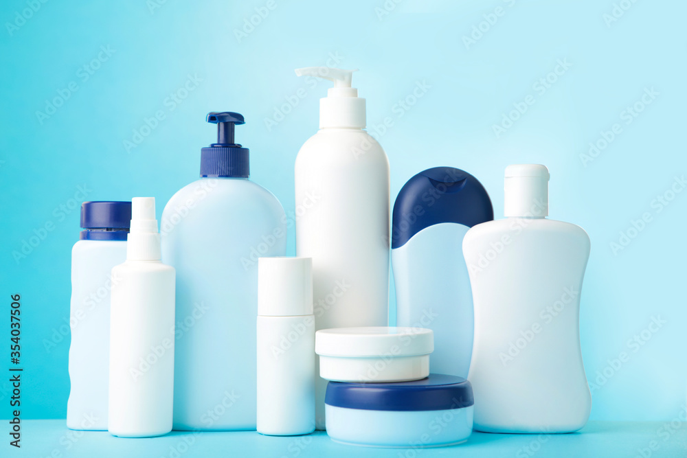 Different cosmetic bottles on blue background. Top view Different cosmetic bottles on blue background. Top view