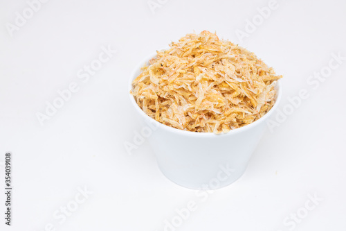 Dried shrimp in a white cup on a white background