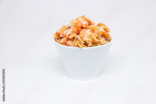 Dried shrimp in a white cup on a white background
