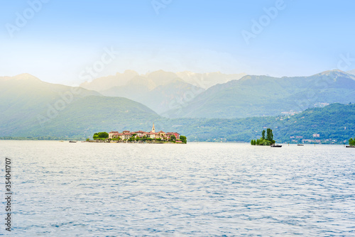 Isola dei Pescatori - fisherman island in Maggiore lake with mountains in the background, Borromean Islands (Isole Borromee), Stresa, Piedmont, Northern Italy - travel destination in Europe. photo