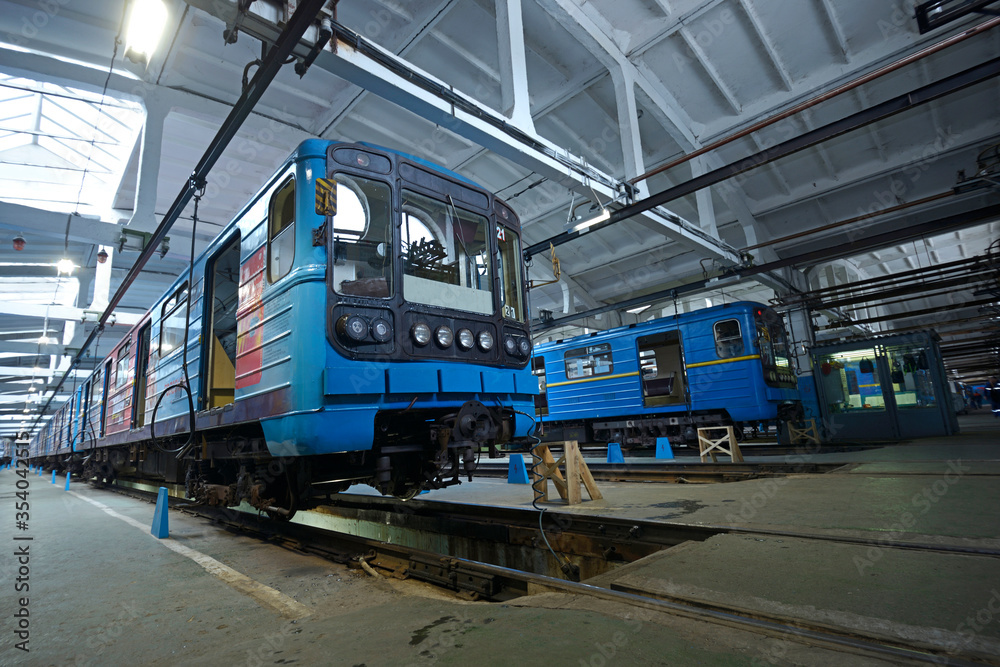 At the maintenance hall: subway trains parked on pits for technical inspection
