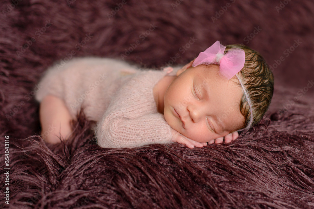 A little newborn girl eight days old. Close-up beautiful sleeping baby girl