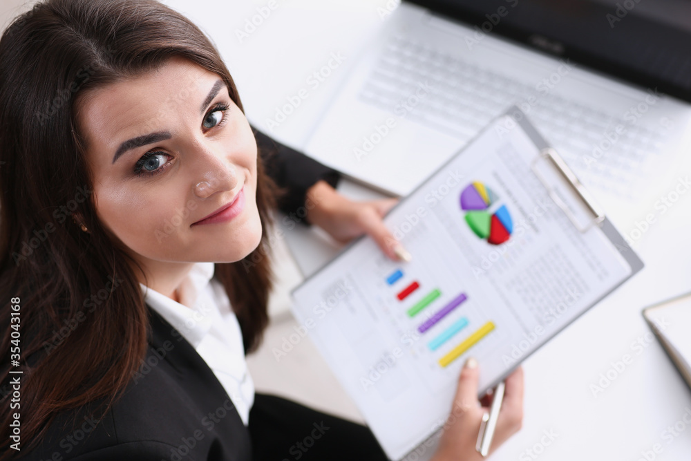 Beautiful smiling cheerful girl at workplace look in camera Beautiful smiling cheerful girl at workplace look in camera