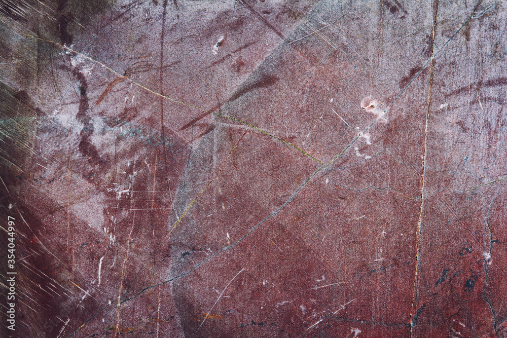 Texture of a red stone surface with cracks and scratches, grunge effect Texture of a red stone surface with cracks and scratches, grunge effect