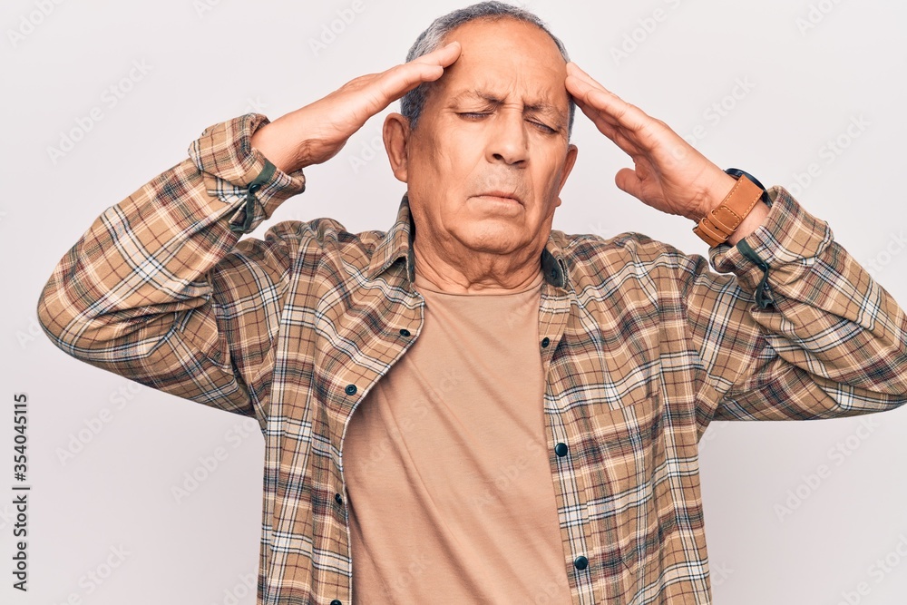 Senior man with grey hair wearing casual shirt with hand on head, headache because stress. suffering migraine. Senior man with grey hair wearing casual shirt with hand on head, headache because stress. suffering migraine.