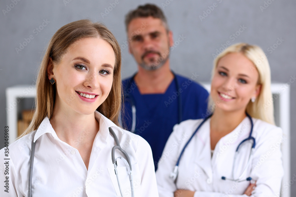 Group of medics proudly posing in row and looking in camera Group of medics proudly posing in row and looking in camera