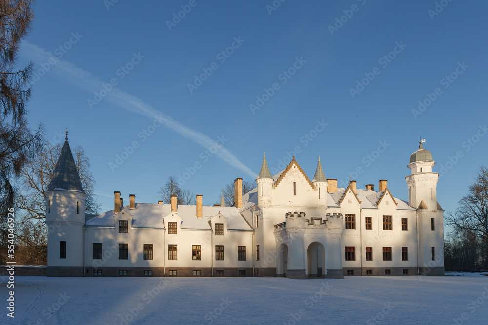 Neo gothic Alatskivi castle at winter. White building and white snow around.