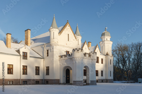 Neo gothic Alatskivi castle at winter. White building and white snow around. photo