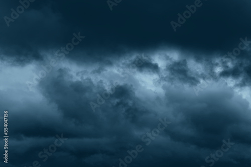 Stormy rain big fluffy clouds. Dark sky. Natural scenic abstract background. Weather changes backdrop. Sky filled with voluminous clouds. © Сyrustr