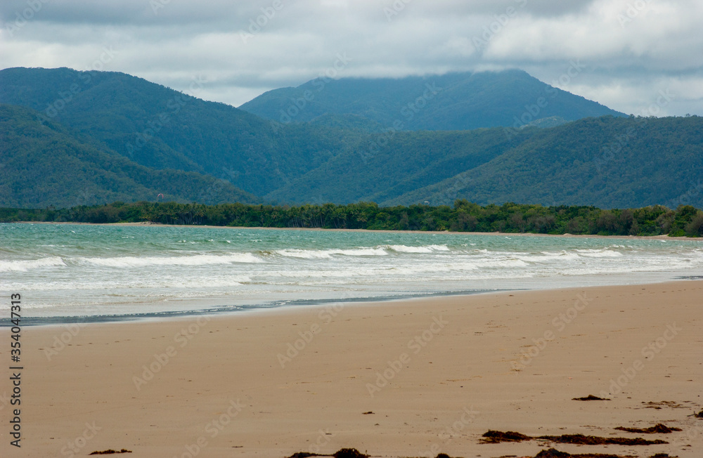 Four mile beach at Port Douglas with heavy storm clouds on the sky Four mile beach at Port Douglas with heavy storm clouds on the sky