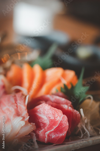 Selective focus of mixed slices of fresh raw salmon sashimi for dinner.