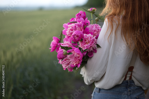 Beautiful girl with a bouquet peony