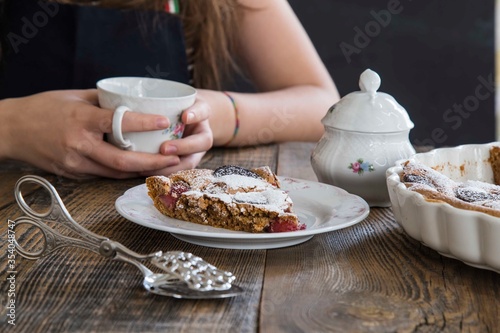 girl drinking cup of tea with brownie. food concept .