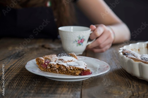girl drinking cup of tea with brownie. food concept .