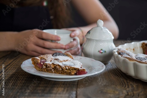 girl drinking cup of tea with brownie. food concept .