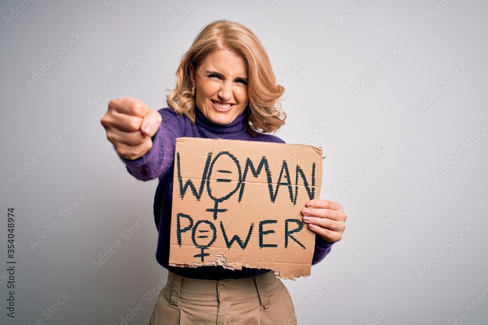 Middle age beautiful blonde woman asking for women rights holding banner annoyed and frustrated shouting with anger, crazy and yelling with raised hand, anger concept Middle age beautiful blonde woman asking for women rights holding banner annoyed and frustrated shouting with anger, crazy and yelling with raised hand, anger concept