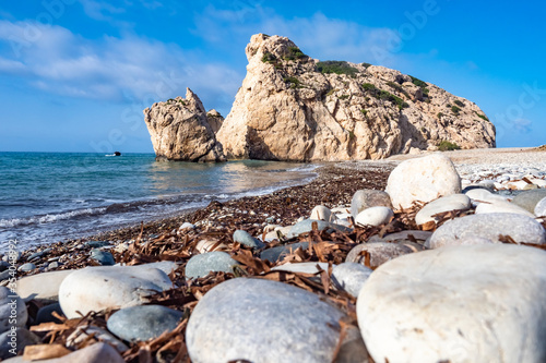 Cyprus beach. Rock of Aphrodite. Cliff Peter Tu Romiu in Cyprus. Aphrodite's stone on the background of blue sky. The places of interest of the Republic of Cyprus. Mediterranean Cruise. photo