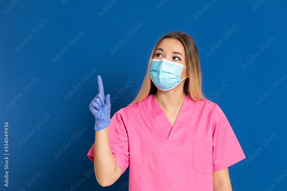 Young doctor wearing a mask face and a pink uniform Young doctor wearing a mask face and a pink uniform