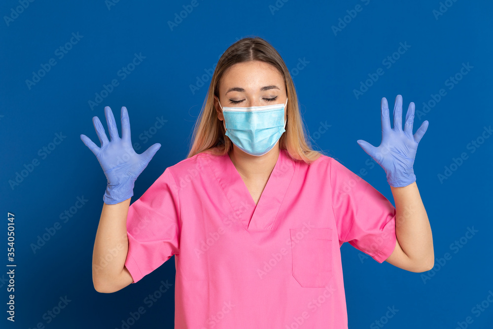 Young doctor wearing a mask face and a pink uniform Young doctor wearing a mask face and a pink uniform