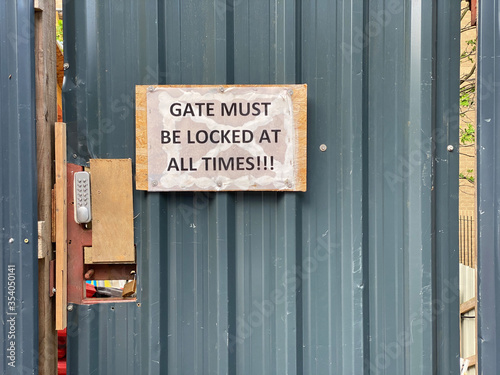 Gate must be locked at all times security sign at construction site