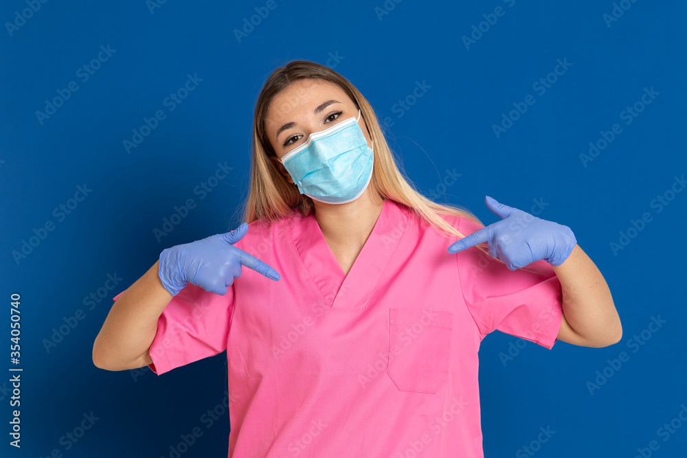 Young doctor wearing a mask face and a pink uniform Young doctor wearing a mask face and a pink uniform