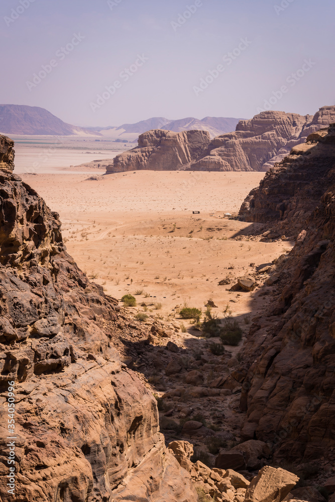 Fototapeta premium Desert with mountains with tents in the background