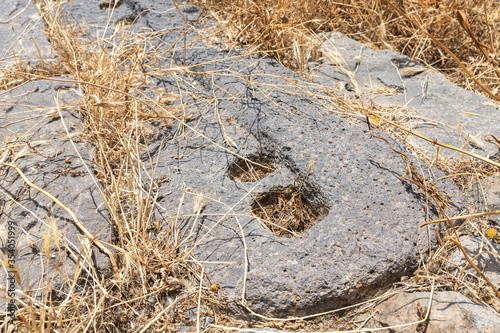 Prehistoric  ritual stone candlestick in ruins of main hall of Dir Aziz Synagogue  built in the Byzantine period  at the beginning of the sixth century AD. It is located on Golan Heights in Israel.