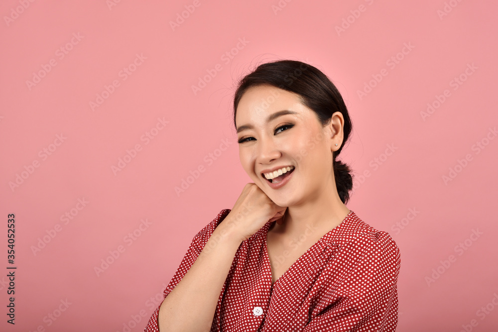 Asian woman laughing and enjoy on pink background, Portrait of happy smiling middle age woman in casual clothes looking at the camera. Asian woman laughing and enjoy on pink background, Portrait of happy smiling middle age woman in casual clothes looking at the camera.