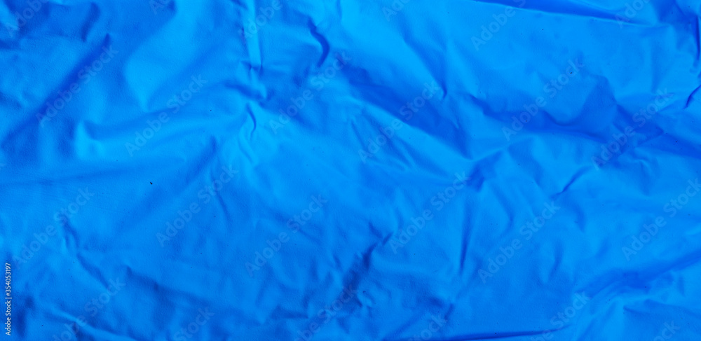 blue wrinkled rubber material. texture or background