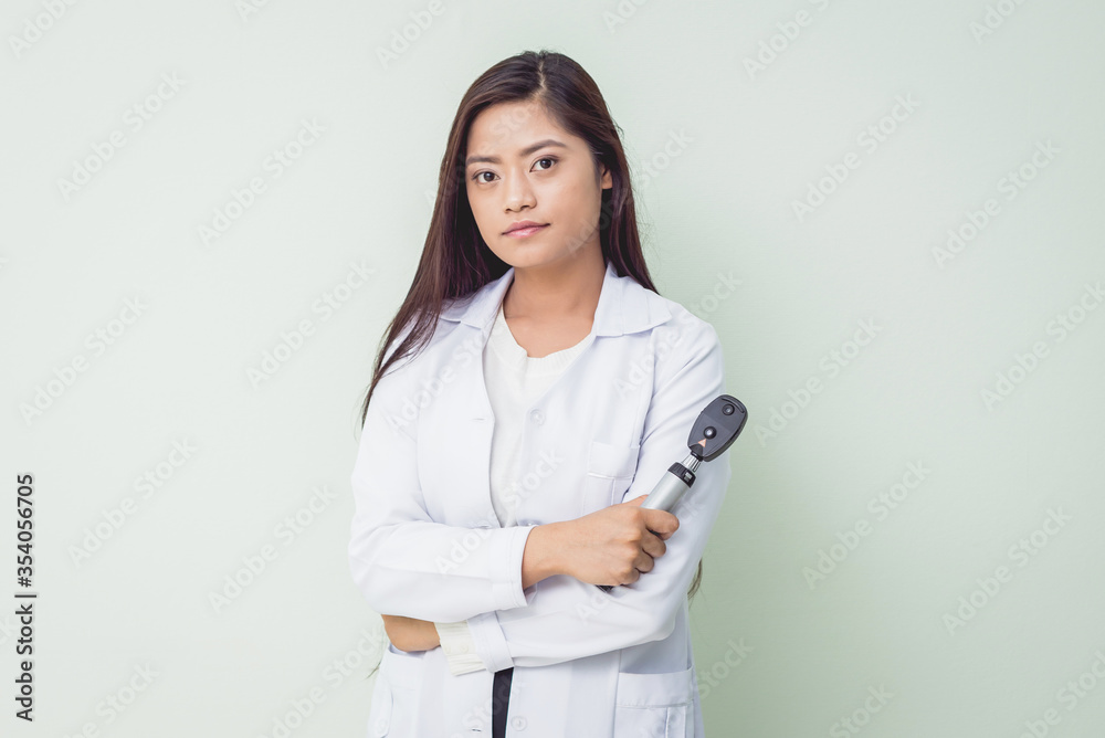 Asian woman ophtalmologist standing at hospital and looking at camera. Asian woman ophtalmologist standing at hospital and looking at camera.