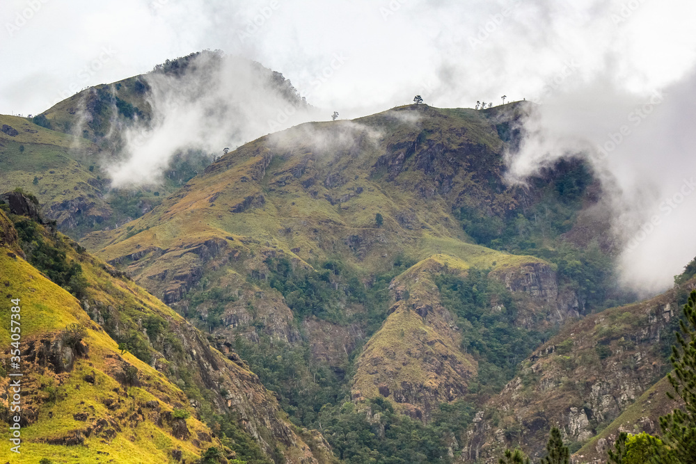 Green mountain range through the clouds creates beautiful landscape scenery