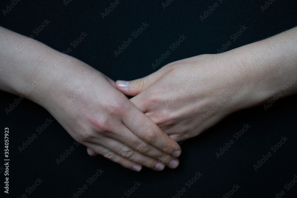 Isolated woman hand closeup making gestures on black background, thinking gesture, speech