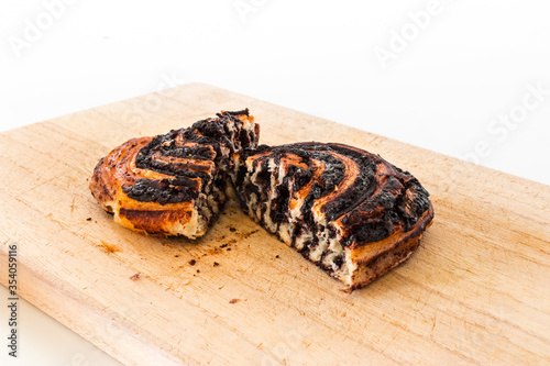 A Hungarian pastry called cocoa roll (kakós csiga) on a wooden cutting board. photo