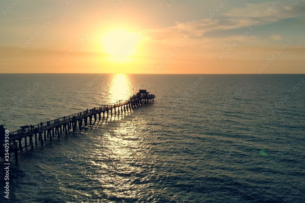 Sunset over the Gulf of Mexico, flying above pier.