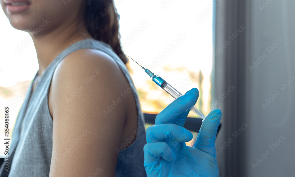Vaccination of patients, Doctor provided a vaccine with a syringe against a new strain of virus or influenza in a modern hospital, Prevention and health care concept. Vaccination of patients, Doctor provided a vaccine with a syringe against a new strain of virus or influenza in a modern hospital, Prevention and health care concept.