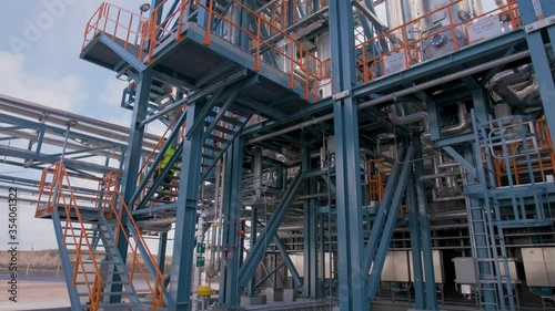 Wallpaper Mural Wide shot of a  staircase at a grey modern newly built industry building. Camera dolly pans from right to left. A construction worker walks right to left down the orange stairs. 4K UHD slowmotion. Torontodigital.ca