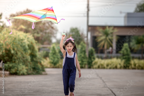 Close-up view of cute girl playing with sports (kite sport), learning outside the classroom during the summer semester and making good use of leisure time.