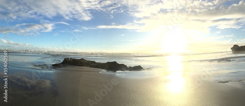 Golden Sunset in a tropical beach With sand, Horse and rock