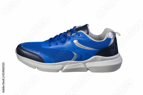 Blue sneaker made of fabric on a white background side view. Sport shoes.