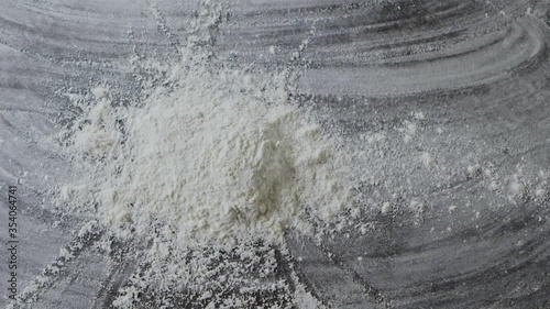 Falling fresh flour on a kitchen background. Powder splash. Slow motion, Full HD video, 240fps, 1080p. Top view. Process preparing of homemade pastry.