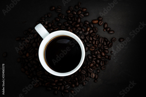 Top view of Instant coffee in cup on dark background with beans and space for putting text